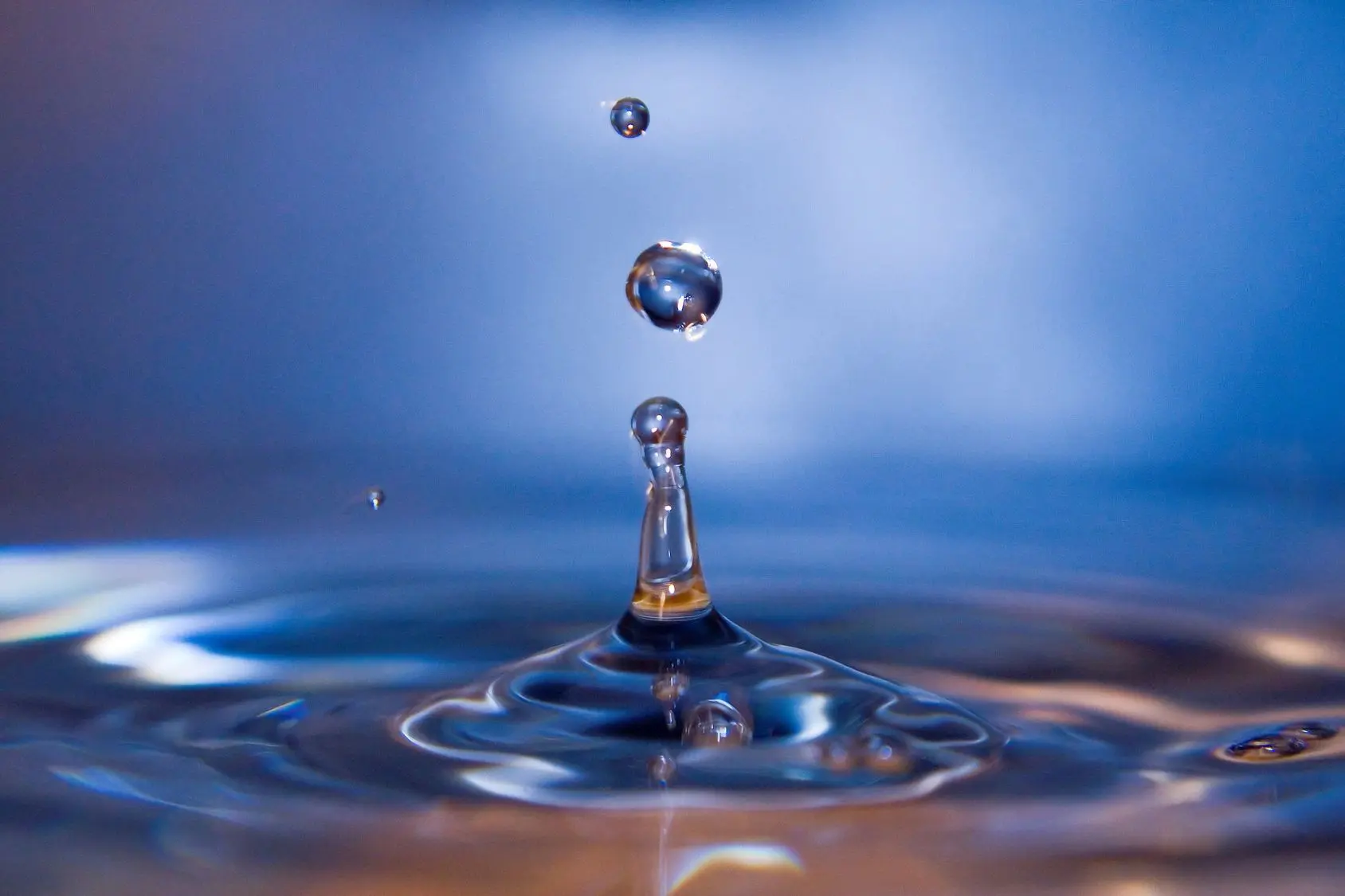 A water drop falling into the water