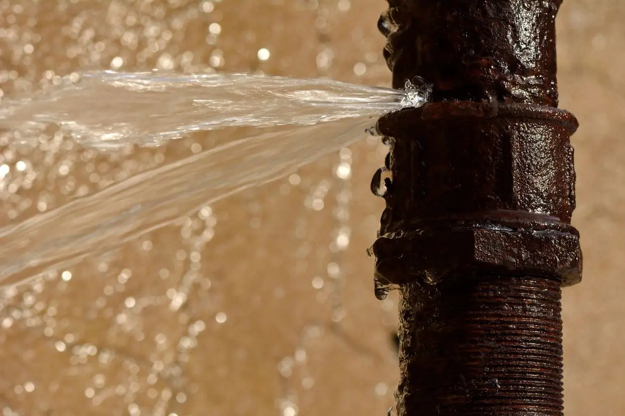 A close up of the water flowing out from a pipe